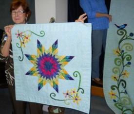 Small wall hanging to match 2012 quilt given back by winner to those who worked on quilt